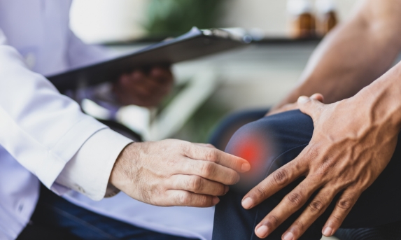 doctor-diagnoses-cause-osteoarthritis-knee-pain-male-patient-examination-room-hospital