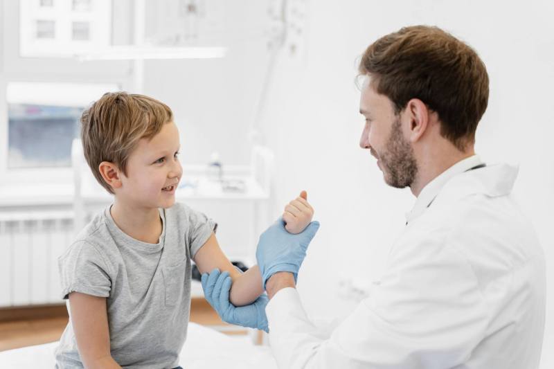 medium-shot-doctor-holding-kid-s-arm-1